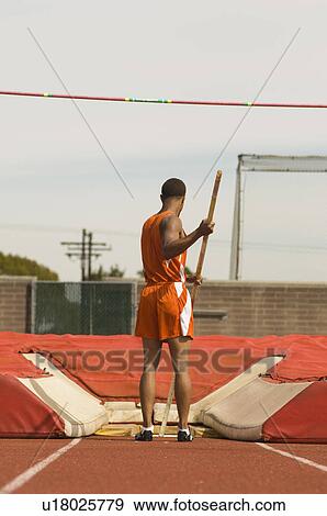 Pole-vaulter preparing for jump View Large Photo Image Stock Photo - Pole-vaulter preparing for jump. Fotosearch