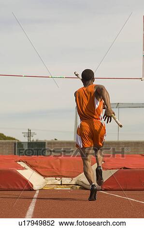Pole-vaulter running with pole View Large Photo Image Stock Image - Pole-vaulter running with pole. Fotosearch