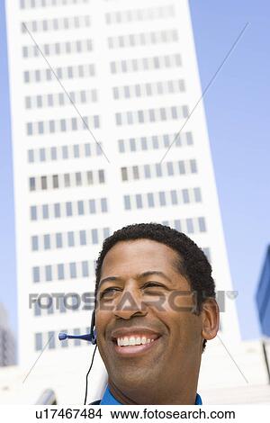 Portrait of businessman with headset, outdoors View Large Photo Image Picture - Portrait of businessman with headset, outdoors. Fotosearch