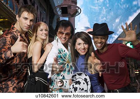 Portrait of group of friends and Elvis impersonator View Large Photo Image Stock Image - Portrait of group of friends and Elvis impersonator. Fotosearch