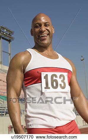 Stock Image - Portrait of laughing runner on a track. Fotosearch