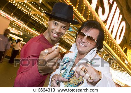Stock Image - Portrait of man and Elvis impersonator. Fotosearch