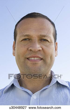 Stock Photo - Portrait of mid-adult man, smiling. Fotosearch