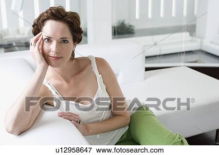 Portrait of mid-adult woman on sofa View Large Photo Image Stock Photo - Portrait of mid-adult woman on sofa. Fotosearch