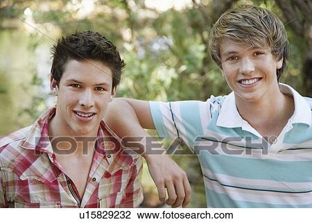 Portrait of two teenage boys (16-17 years) in forest, smiling View Large Photo Image Stock Image - Portrait of two teenage boys (16-17 years) in forest, smiling. Fotosearch
