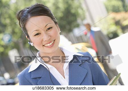 Stock Photography - Portrait of young businesswoman at street. Fotosearch