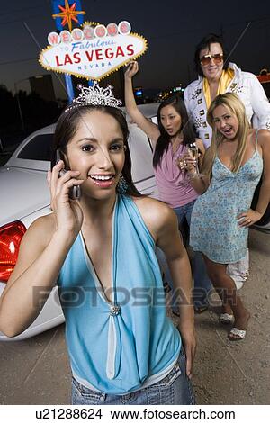 Portrait of young woman, two women with Elvis impersonator in background, Las Vegas, Nevada, USA View Large Photo Image Picture - Portrait of young woman, two women with Elvis impersonator in background, Las Vegas, Nevada, USA. Fotosearch