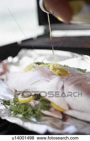 Pouring oil over Fish on Grill View Large Photo Image Stock Photo - Pouring oil over Fish on Grill. Fotosearch
