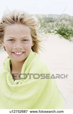 Pre-teen Boy Wrapped in a Towel, standing on beach View Large Photo Image Stock Photo - Pre-teen Boy Wrapped in a Towel, standing on beach. Fotosearch