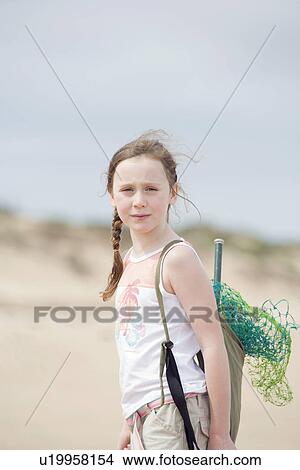 Pre-teen girl standing on beach View Large Photo Image Picture - Pre-teen girl standing on beach. Fotosearch