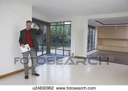 Real estate agent photographing new property View Large Photo Image Stock Image - Real estate agent photographing new property. Fotosearch