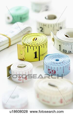 Stock Photo - Rolls of measuring tape, close-up. Fotosearch