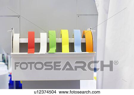 Picture - Rolls of multi-coloured labelling tape in laboratory. Fotosearch