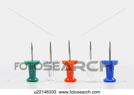 Stock Image - Row of five push pins with points facing up, close up. Fotosearch