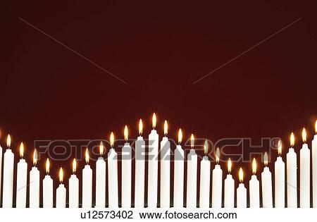 Row of lit candles, on black background View Large Photo Image Stock Image - Row of lit candles, on black background. Fotosearch