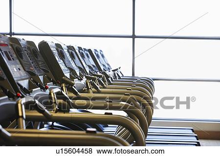 Stock Photo - Row of Treadmills in health club. Fotosearch
