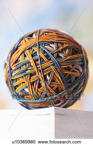Rubber Band Ball resting on book View Large Photo Image Stock Image - Rubber Band Ball resting on book. Fotosearch
