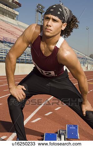 Runner on a track, stretching View Large Photo Image Stock Image - Runner on a track, stretching. Fotosearch