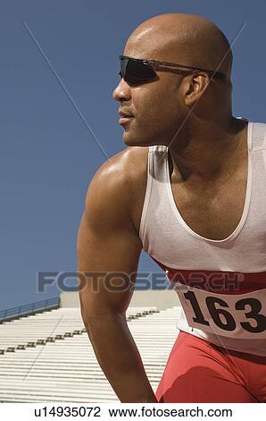 Runner with sunglasses on a track View Large Photo Image Stock Image - Runner with sunglasses on a track. Fotosearch