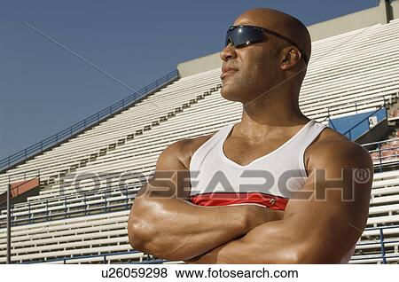 Stock Photo - Runner with sunglasses on a track. Fotosearch