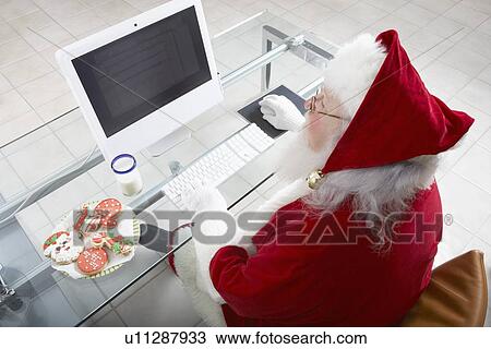 Stock Image - Santa Claus Using Computer. Fotosearch