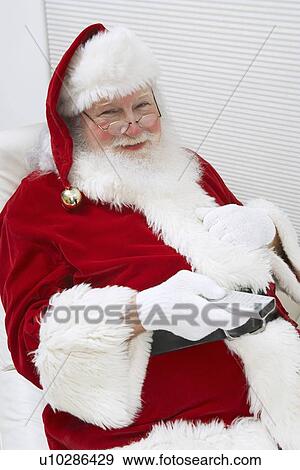 Santa Claus Using Remote Control View Large Photo Image Stock Photo - Santa Claus Using Remote Control. Fotosearch