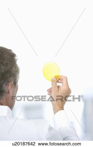 Stock Image - Scientist holding sample in laboratory. Fotosearch