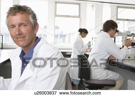 Scientists working in laboratory View Large Photo Image Stock Photo - Scientists working in laboratory. Fotosearch