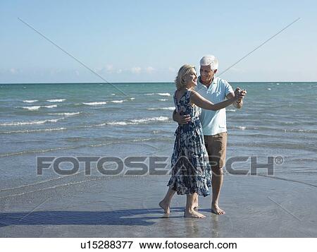 Stock Photo - Senior Couple Dancing on Beach. Fotosearch