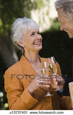 Stock Image - Senior couple drinking champagne. Fotosearch