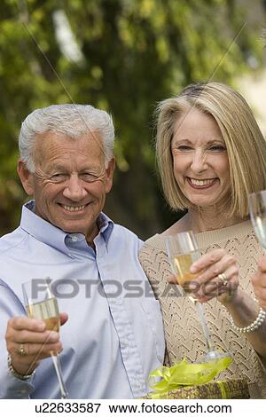 Senior couple drinking champagne View Large Photo Image Stock Photo - Senior couple drinking champagne. Fotosearch