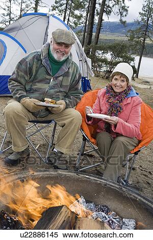 Senior couple eating by tent View Large Photo Image Stock Photography - Senior couple eating by tent. Fotosearch