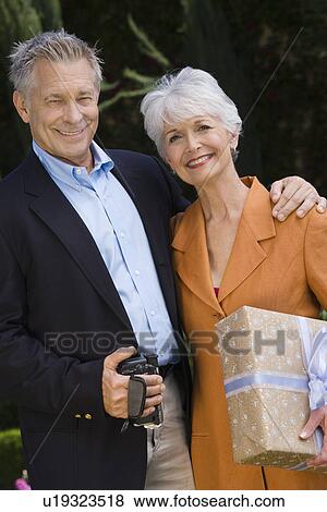 Senior couple embracing and smiling View Large Photo Image Stock Photo - Senior couple embracing and smiling. Fotosearch