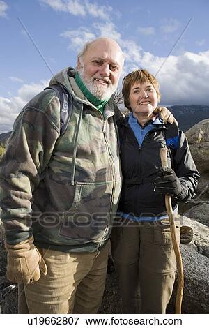 Senior couple embracing in mountains, portrait View Large Photo Image Stock Photo - Senior couple embracing in mountains, portrait. Fotosearch