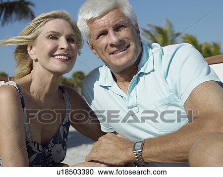 Senior couple holding hands on tropical beach, close up View Large Photo Image Stock Image - Senior couple holding hands on tropical beach, close up. Fotosearch