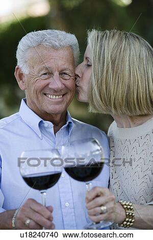 Senior couple holding wineglasses View Large Photo Image Stock Image - Senior couple holding wineglasses. Fotosearch