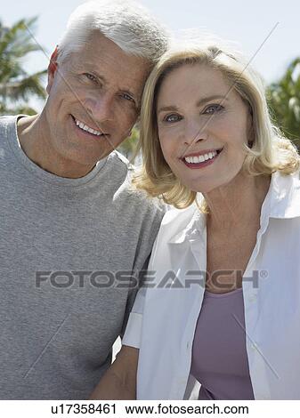 Stock Image - Senior couple on tropical holiday, close up. Fotosearch