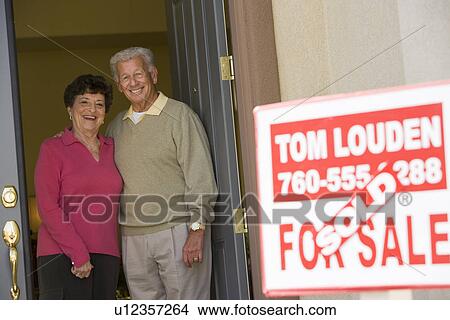 Senior couple standing in doorway of their new home View Large Photo Image Picture - Senior couple standing in doorway of their new home. Fotosearch