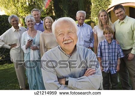 Stock Photo - Senior man celebrating with friends in garden. Fotosearch