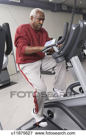Senior Man Exercising on Stationary Bike View Large Photo Image Stock Photo - Senior Man Exercising on Stationary Bike. Fotosearch