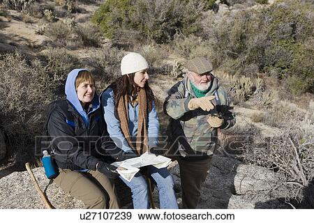 Senior man holding binoculars with friends View Large Photo Image Stock Photo - Senior man holding binoculars with friends. Fotosearch