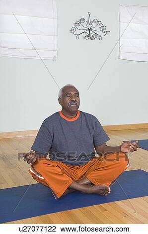 Stock Image - Senior Man Meditating. Fotosearch