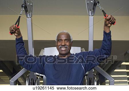 Stock Photography - Senior Man Working Out on Weightlifting Machine. Fotosearch