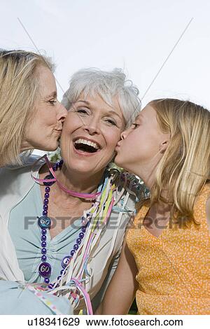 Senior woman being kissed by daughter and granddaughter View Large Photo Image Stock Photo - Senior woman being kissed by daughter and granddaughter. Fotosearch