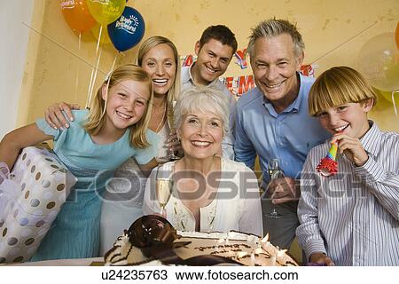 Senior woman celebrating birthday with family View Large Photo Image Stock Image - Senior woman celebrating birthday with family. Fotosearch