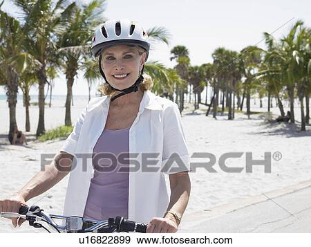 Stock Photo - Senior Woman Cycling. Fotosearch