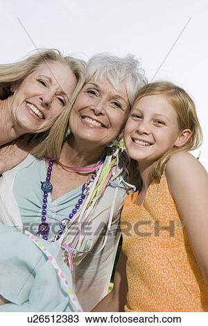 Senior woman embracing daughter and granddaughter View Large Photo Image Stock Image - Senior woman embracing daughter and granddaughter. Fotosearch
