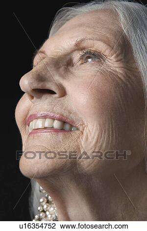 Stock Image - Senior Woman, looking up. Fotosearch