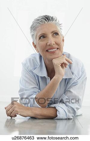 Senior woman lying on floor View Large Photo Image Stock Image - Senior woman lying on floor. Fotosearch