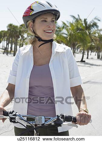 Senior woman on bicycle on tropical beach View Large Photo Image Stock Image - Senior woman on bicycle on tropical beach. Fotosearch